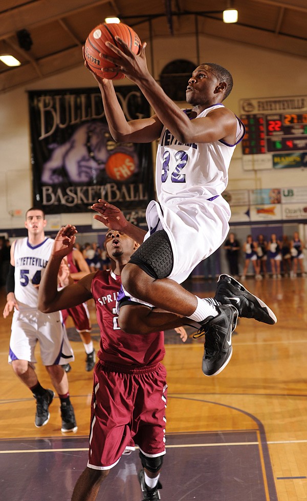 Manny Watkins, right, a Fayetteville guard, leads the Fayetteville Bulldogs in scoring with 112 points in seven conference games. 