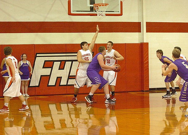 MARK HUMPHREY STAFF PHOTO -- Berryville's 6-foot-6 center, Josh Morrell, works against a Farmington double team of Michael Ryan (left) and Chase Garner in the low post. Morrell scored 14 points but Berryville lost 53-46 to Farmington on Tuesday.