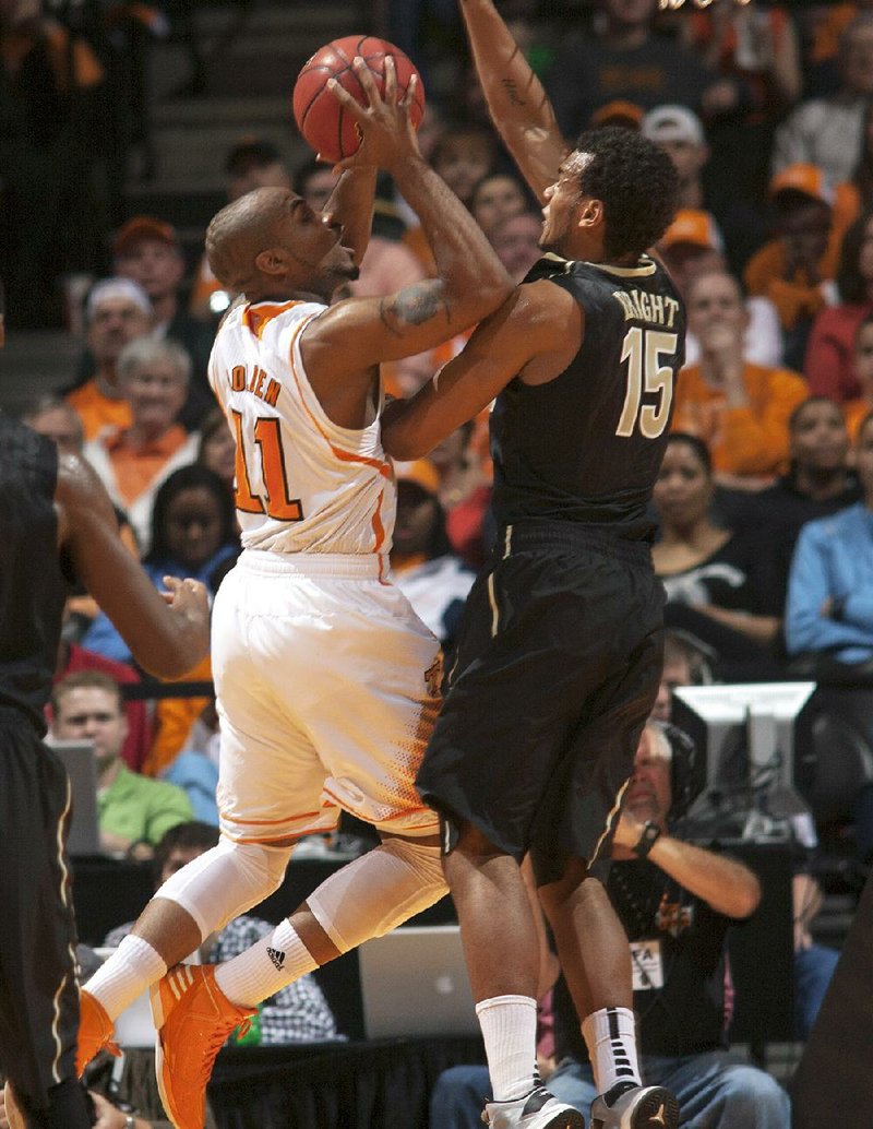 Tennessee guard Trae Golden (11) goes up for a basket as Vanderbilt guard Kevin Bright (15) defends during the first half of an NCAA college basketball game Tuesday, Jan. 29, 2013, in Knoxville, Tenn. (AP Photo/Knoxville News Sentinel, Adam Brimer)
