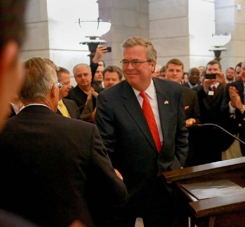 
Jim Walton, CEO of Arvest Bank Group, left, greets former Florida Gov. Jeb Bush before Bush addressed a crowd during the A+ Arkansas Education Rally Tuesday morning in the rotunda at the State Capitol in Little Rock. 