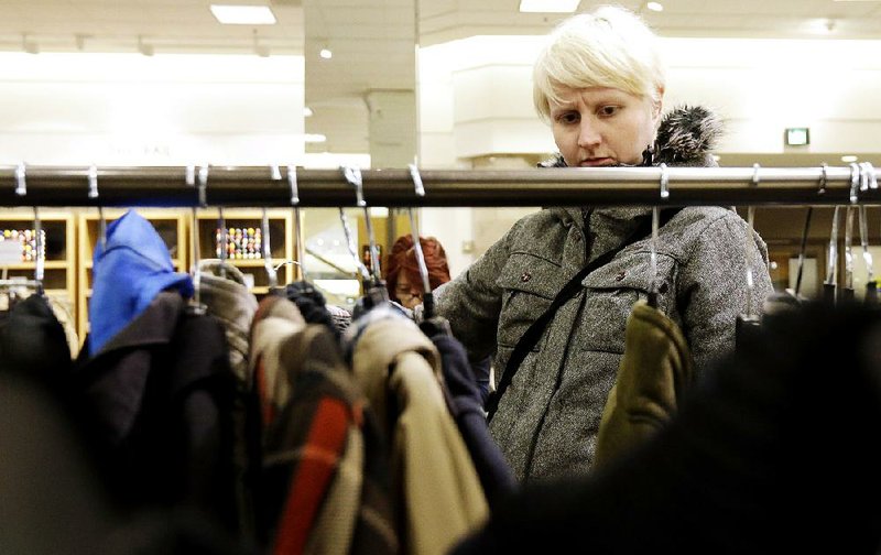 In this Thursday, Jan. 20, 2013, photo, a woman shops at a Nordstrom store in Chicago. U.S. consumer confidence plunged in January to its lowest level in more than a year, reflecting higher Social Security taxes that left Americans with less take-home pay.  (AP Photo/Nam Y. Huh)