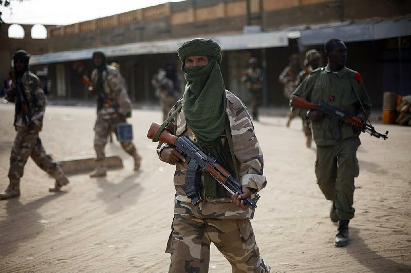 Chadian soldiers patrol the streets vacated by Islamic extremists  in Gao, Northern Mali, Tuesday Jan. 29, 2013, days after Malian and French military forces closed in and retook the town from Islamist rebels. Earlier Tuesday, four suspected extremists were arrested after being found by a youth militia calling themselves the "Gao Patrolmen". Malian soldiers prevented the mob from lynching them. (AP Photo/Jerome Delay)