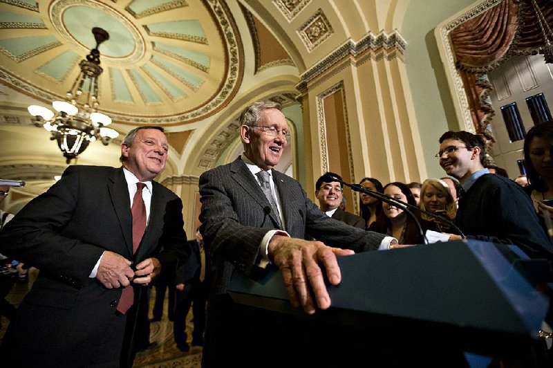 Assistant Majority Leader Sen. Richard Durbin, D-Ill., left, joins Senate Majority Leader Harry Reid, D-Nev., right, as they meet with reporters following a weekly Democratic strategy session, at the Capitol in Washington, Tuesday, Jan. 29, 2013.   (AP Photo/J. Scott Applewhite)