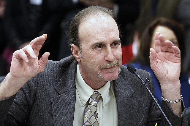 Ray Krone of Arizona, who was wrongfully convicted of murder in 1992, and sentenced to death, gestures as he speaks  against the death penalty during a meeting of Senate Committee on Judiciary at the Arkansas state Capitol in Little Rock, Ark., Wednesday, Jan. 30, 2013. (AP Photo/Danny Johnston)