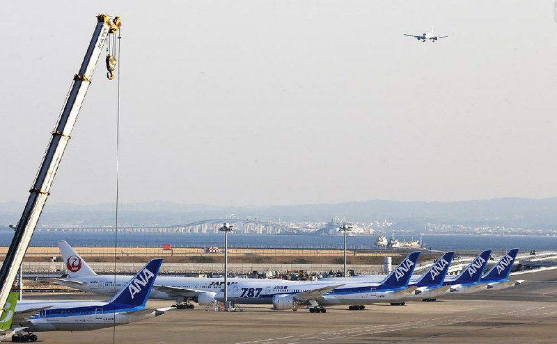 Several All Nippon Airways' Boeing 787 Dreamliners sit on the tarmac at Haneda Airport in Tokyo, Wednesday, Jan. 30, 2013. U.S. regulators said Wednesday they asked Boeing Co. to provide a full operating history of lithium-ion batteries used in its grounded 787 Dreamliners after Japan's All Nippon Airways revealed it had repeatedly replaced the batteries even before overheating problems surfaced. (AP Photo/Shizuo Kambayashi)