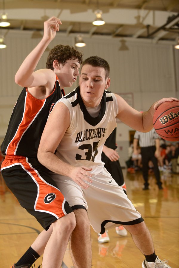 Isaac Mangrum, right, of Pea Ridge drives to the basket under pressure from Gravette’s Otto Troutner during Tuesday’s game in Pea Ridge.