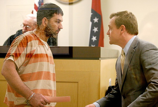 Timothy Swinford talks with public defender Tyler Benson in the courtroom Wednesday at the Washington County Jail in Fayetteville for arraignment with Judge Ray Reynolds. Swinford is one of four people facing felony charges in connection with accomplice to capital murder, engaging in violent criminal group activity and kidnapping. 