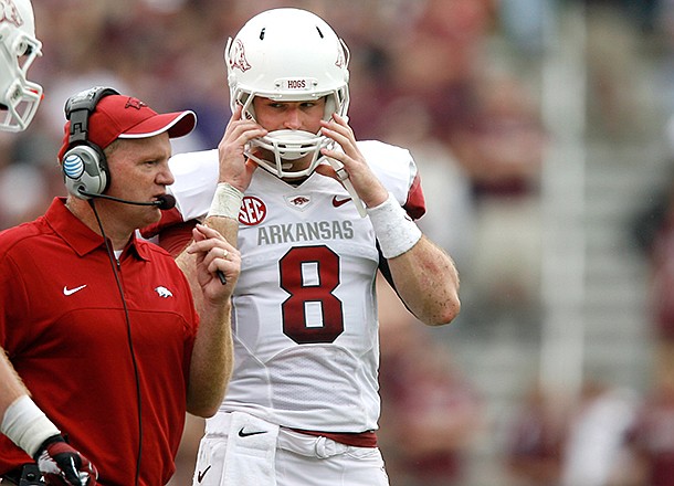 NWA Media/JASON IVESTER -- Arkansas offensive coordinator Paul Petrino talks to quarterback Tyler Wilson during the second quarter against Texas A&M on Saturday, Sept. 29, 2012, at Kyle Field in College Station, Texas.