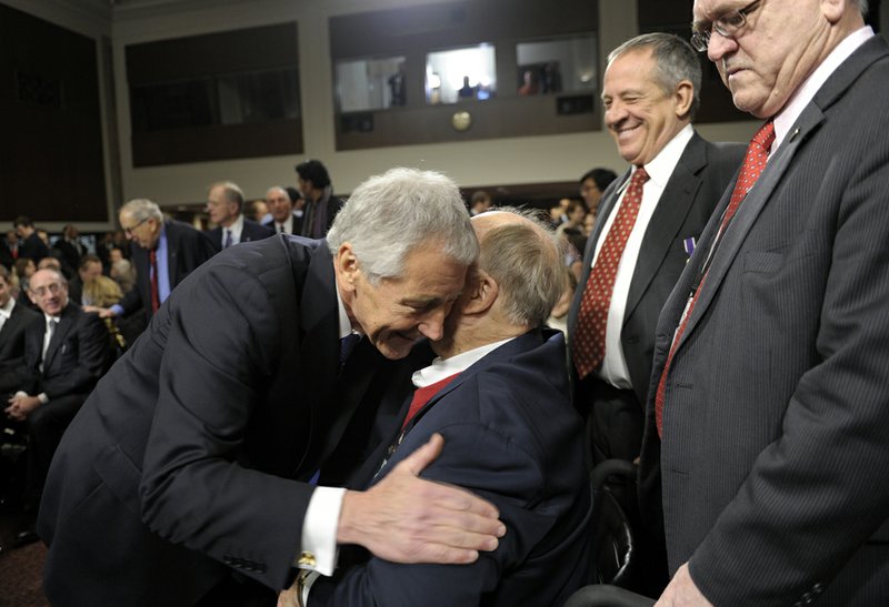 Former Nebraska Republican Sen. Chuck Hagel, left, President Barack Obama's choice for defense secretary, greets former Georgia Sen. Max Cleland, center, after arriving on Capitol Hill in Washington, Thursday, Jan. 31, 2013, to testify before the Senate Armed Services Committee hearing on his nomination. 