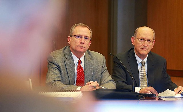 Arkansas Athletic Director Jeff Long (left) and Donald Pederson, vice chancellor for finance and administration, answer questions concerning expansion plans to Reynolds Razorback Stadium at a meeting of the UA board of trustees Thursday. 