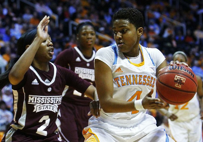 Tennessee guard Kamiko Williams (4) works around Mississippi State guard Darriel Gaynor during the first half of Thursday’s game in Knoxville, Tenn. Tennessee won 88-45. Williams, making her first start of the season, finished with 10 points and 13 rebounds. 