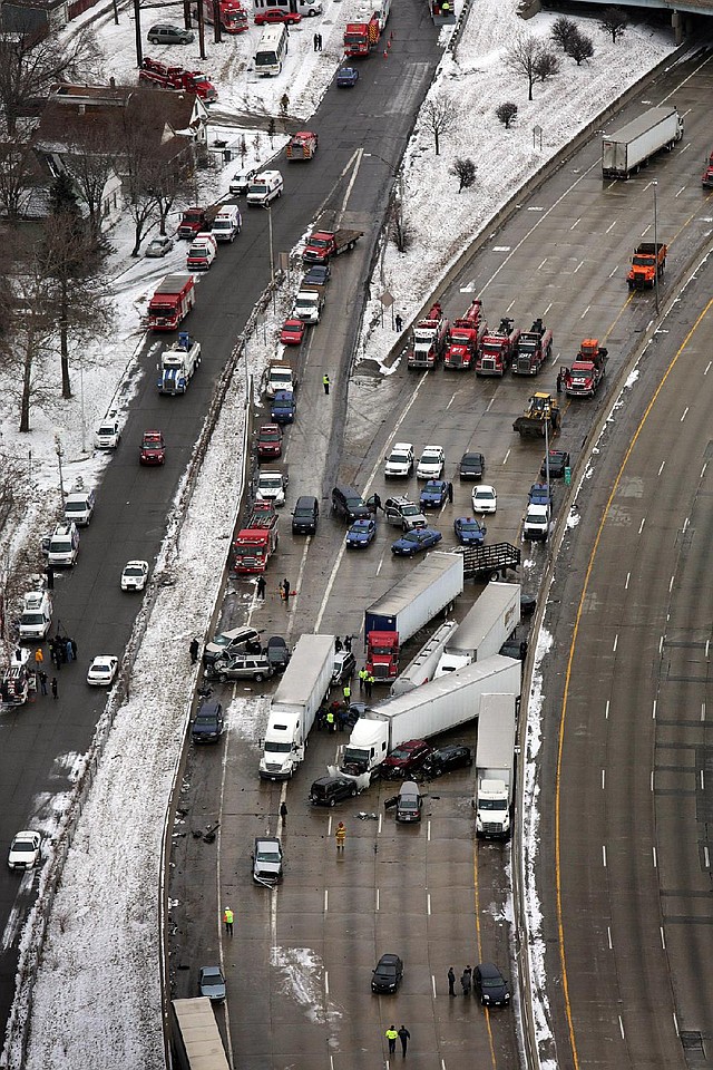Vehicles sit in a tangle after a whiteout Thursday caused a mile long series of crashes along Interstate 75 on the southwest side of Detroit.