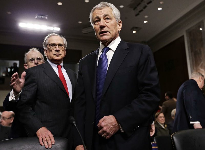 Chuck Hagel, a former two-term senator and President Barack Obama’s choice to lead the Pentagon, arrives Thursday at the Senate Armed Services Committee for his confirmation hearing on Capitol Hill. Former committee chairman Sam Nunn (left) introduced Hagel.