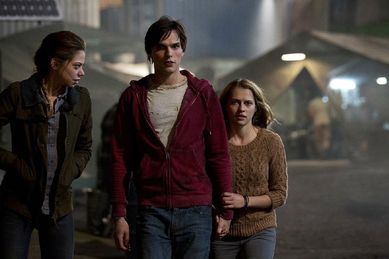 Zombies Nora (Analeigh Tipton) and R (Nicholas Hoult) are starting to bond with human Julie (Teresa Palmer) in Jonathan Levine’s offbeat romantic comedy Warm Bodies. 