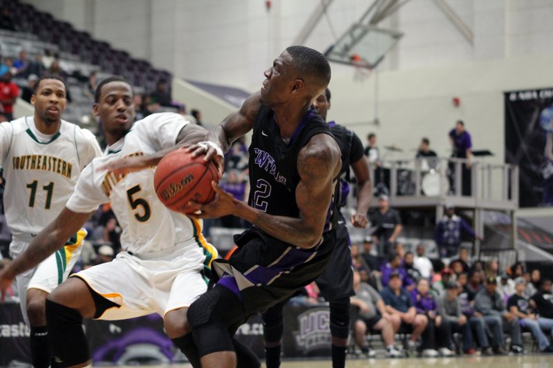 Central Arkansas junior guard LaQuentin Miles (right) tries to score against Southeastern Louisiana guard Brandon Fortenberry on Thursday night at the Farris Center in Conway. Miles scored 15 points in a 70-69 loss. 