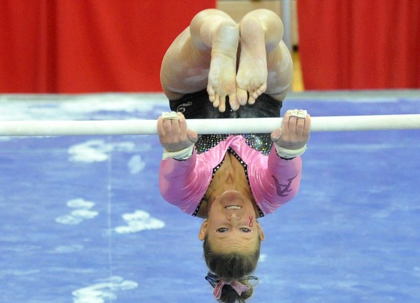 NWA Media/MICHAEL WOODS --02/01/2013-- University of Arkansas gymnast Erin Freier does a flip on the bars during Friday night's meet against Florida at Barnhill Arena in Fayetteville. 