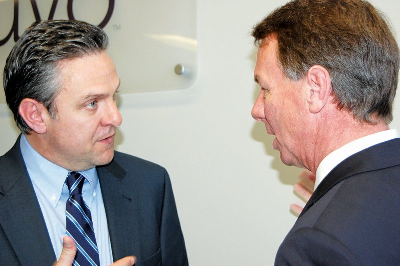 Richard Howe of Little Rock, left, chairman and CEO of Inuvo, an Internet marketing and technology company, talks with Conway Mayor Tab Townsell after an announcement that Inuvo will move its headquarters from New York to Conway, creating 50 jobs. A third of the jobs will be filled by employees transferred from elsewhere; the remainder will be hired in Arkansas, officials said.