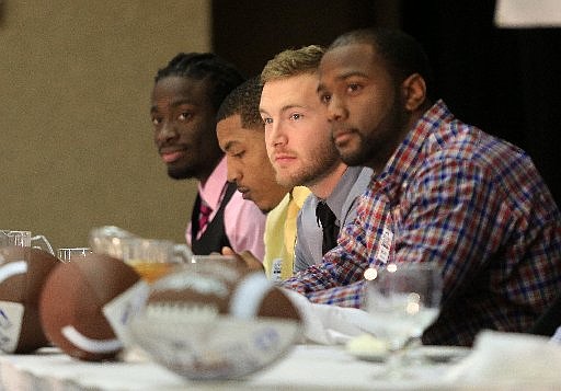 Award winners (left to right) Jimmy Jean of Arkansas Baptist, Jamal Nixon of the University of Arkansas Monticello, Tanner Marsh of Arkansas Tech, and Kelvin Martin of Harding listen to introductions Friday afternoon during the Little Rock Touchdown Club awards banquet.