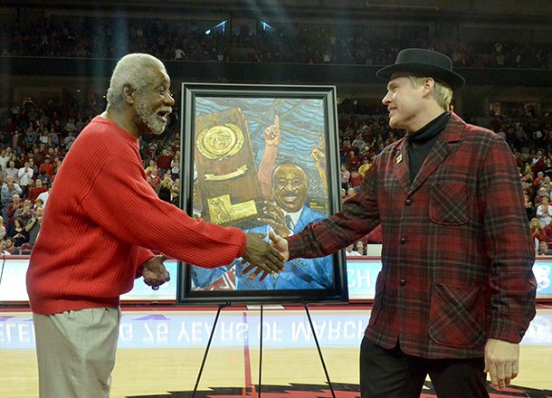 NWA Media/MICHAEL WOODS --02/02/2013-- Former University of Arkansas basketball coach Nolan Richardson shakes hand with artist Opie Otterstad during a halftime presentation of Saturday afternoon's game against Tennessee at Bud Walton Arena in Fayetteville.
