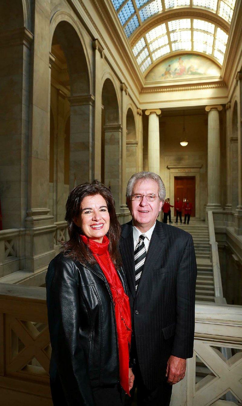Ted Mullenix and his wife, Julie, stand outside the state House chamber Friday. Lawmakers consider them the top lobbying team in the state. Mullenix’s firm spent $59,510 on lobbying in 2011. 