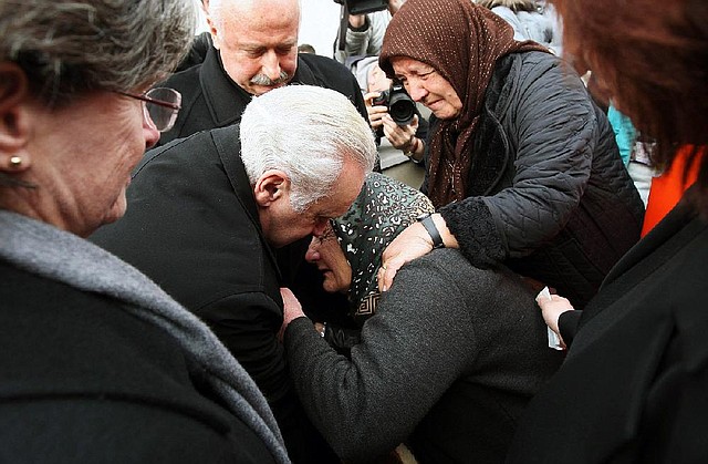 Francis Ricciardone (left), U.S. ambassador to Turkey, consoles a relative of Mustafa Akarsu during a funeral Saturday in Ankara for the security guard who was killed in a suicide bombing Friday at the U.S. Embassy. 