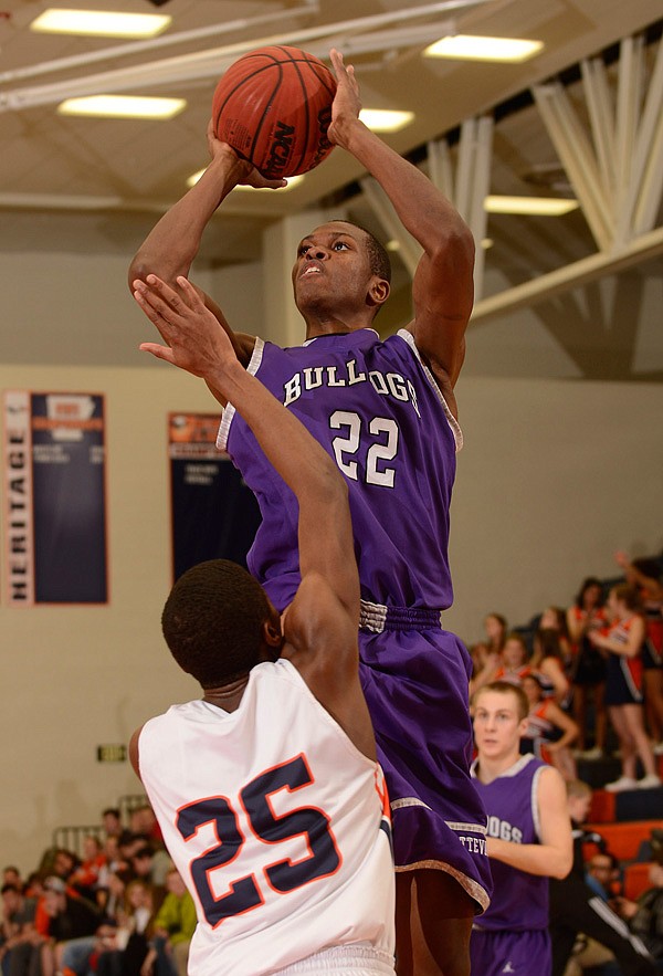 Trey Boyd of Fayetteville shoots over Rogers Heritage’s Xavier Thomas on Friday in Rogers 