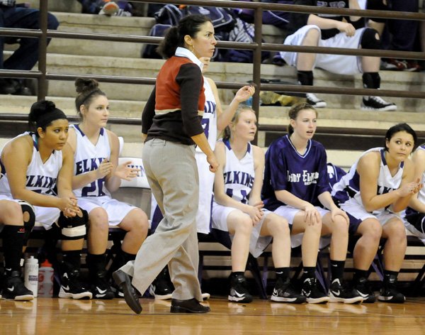 Monica Wells, (above) Elkins girls coach, watches her team play West Fork in the first half Tuesday in Elkins. (Below) Nathan Wells, West Fork girls coach, calls out to his team Tuesday as they play Elkins. 