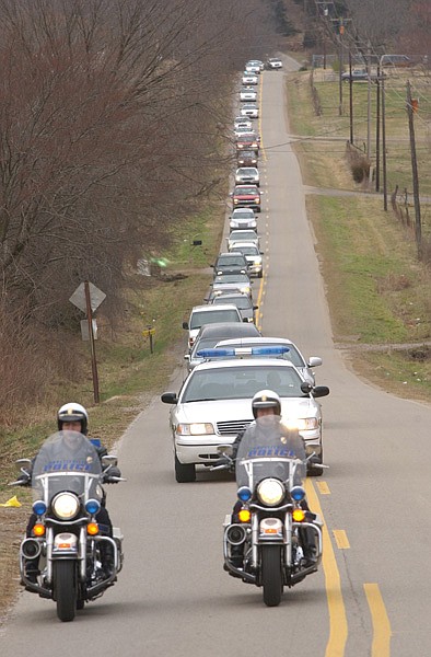 Police escorts for funeral processions, as seen in this 2003 Northwest Arkansas Times photo, once were common in Arkansas towns. Today, only four of Arkansas’ largest cities still provide the service. 