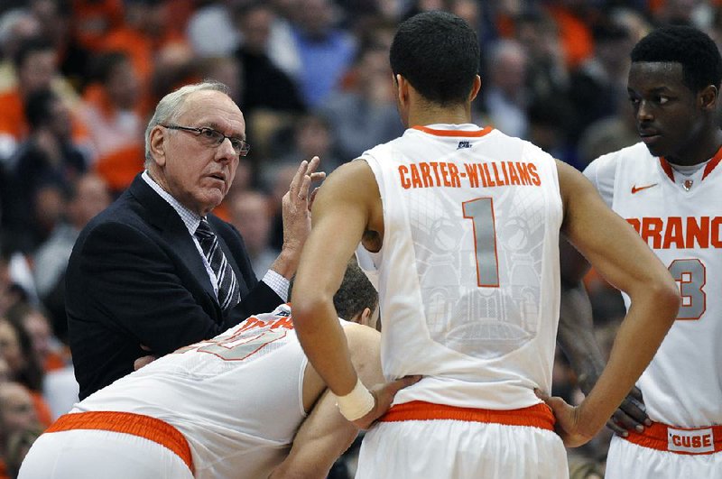 Syracuse Coach Jim Boeheim (left) talks with his players during a timeout in the second half of Monday’s game against Notre Dame in Syracuse, N.Y. Boeheim was able to breathe a sigh of relief after Syracuse won 63-47. “When you lose two games in a row in this league, you get nervous,” Boeheim said. 