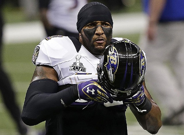Baltimore Ravens linebacker Ray Lewis (52) puts on his helmet before taking the field for Sunday’s game against the San Francisco 49ers. Lewis announced his retirement earlier in the season, meaning the Super Bowl would be his last game. 
