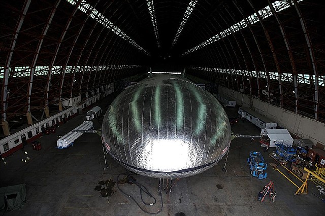 Work is almost done on a 230-foot, rigid airship inside a blimp hangar at a former military base in Orange County, Calif. The Aeroscraft airship, designed to carry cargo, has a shiny, aluminum skin and an aluminum and carbon-fiber skeleton. 
