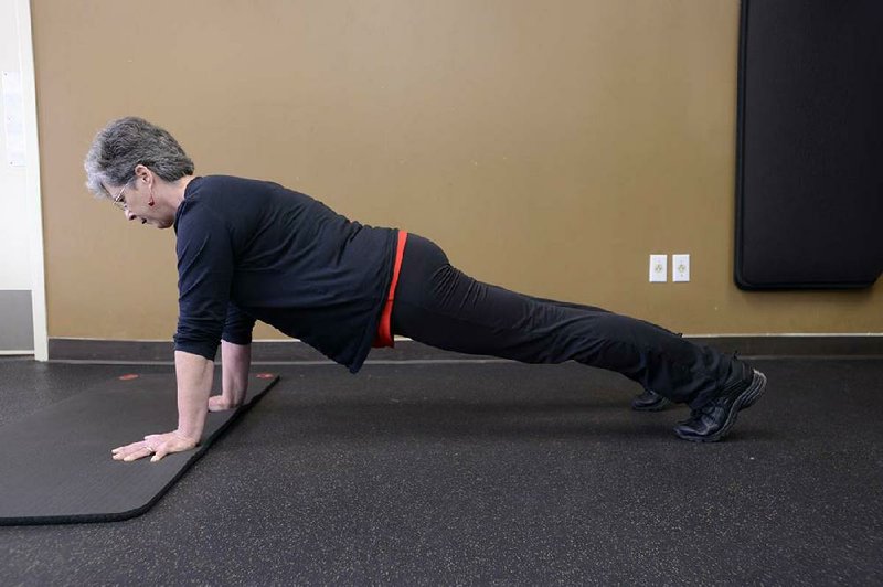 Linda Walker demonstrates the Half Burpee at Little Rock Racquet Club.

