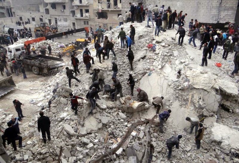 Syrians search through the debris of destroyed buildings on Sunday after an airstrike hit the neighborhood of Eastern Ansari in Aleppo, Syria. The Britain-based Syrian Observatory for Human Rights said the bombardment by Syrian troops killed at least 16 people, including 10 children. 