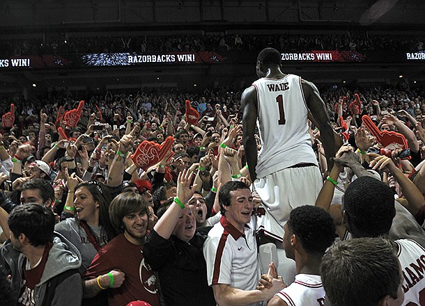 NWA MEDIA/SAMANTHA BAKER -- Arkansas' Mardracus Wade climbs into the stands after the Razorbacks beat No. 2 Florida Tuesday, Feb. 5, 2013, at Bud Walton Arena in Fayetteville. Arkansas upset the Gators, 80-69.