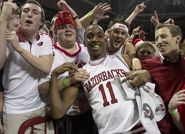 Arkansas' BJ Young (11) celebrates with fans after their 80-69 win over No. 2 Florida in an NCAA college basketball game in Fayetteville, Ark., Tuesday, Feb. 5, 2013. (AP Photo/Gareth Patterson)