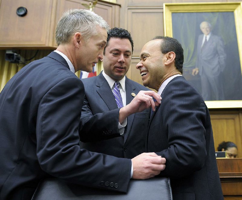 House Judiciary Committee member Rep. Jason Chaffetz, R-Utah, center, adjusts the flag pin on fellow committee member Rep. Luis Gutierrez, D-Ill., right, as they share a laugh with Rep. Trey Gowdy, R-S.C., on Capitol Hill in Washington, Tuesday, Feb. 5, 2013, prior to the committee's hearing on America's Immigration System: Opportunities for Legal Immigration and Enforcement of Laws against Illegal Immigration.  (AP Photo/Susan Walsh)