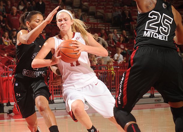 Arkansas sophomore guard Calli Berna, center, drives with the basketball as South Carolina senior guard Ieasia Walker, left, and freshman guard Tiffany Mitchell, right, defend during the second half Sunday, Jan. 27, 2013, in Bud Walton Arena.