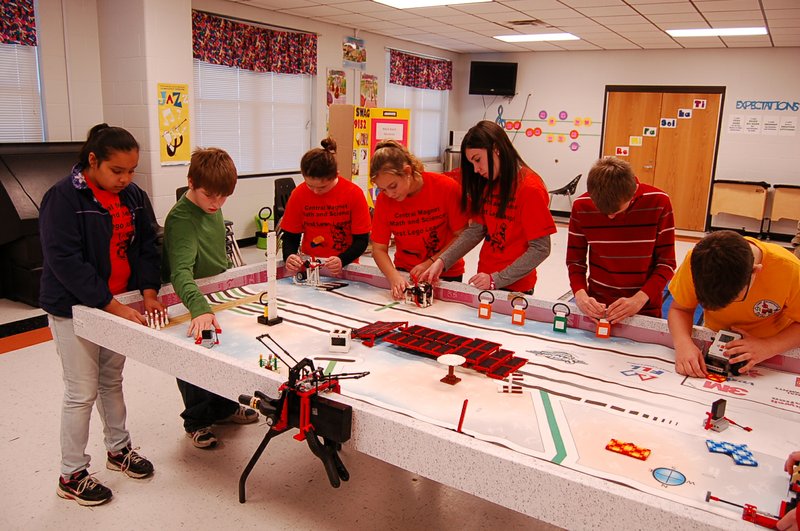 The First Lego League of Central Magnet Elementary School works on setting up the course for the league’s robot to complete 15 missions. From the left are Enelyn Hernandez, Jacob Wolform, Lexie Rice, Allison Fredricks, Lauren McDaniel, Cody Tosh and Kyler Stolark.