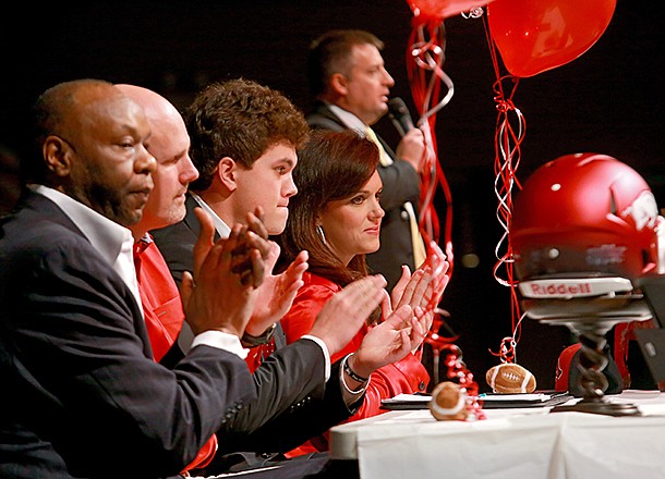 Pulaski Academy's tight end Hunter Henry, center, applauded as his coach Kevin Kelley, upper right speaks during a signing ceremony at the school Wednesday afternoon in Little Rock. From left is Henry family friend and former coach Walter Jordan, father Mark Henry his mother Jenny Henry. 