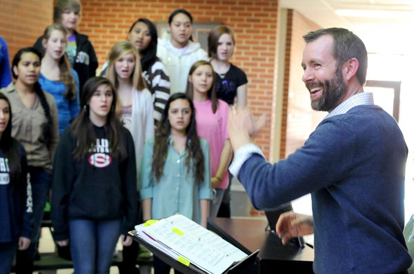 Alan Showalter, choir director at Southwest Junior High School, leads the Harmony Choir through a practice Tuesday at the Springdale school. The group is practicing for a concert Tuesday and a performance at the Arkansas All-State Music Conference on Feb. 15 in Hot Springs. The Harmony choir is one of three invited to perform from across the state. 