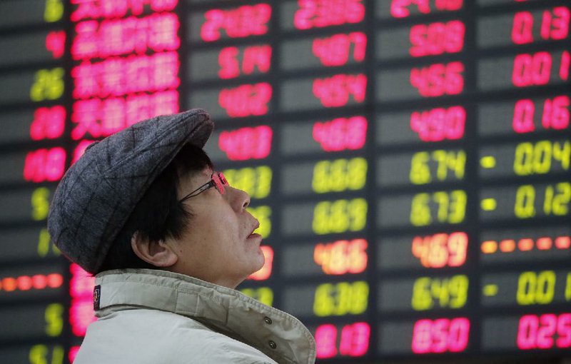 An investor looks at the stock price monitor at a private securities company Wednesday, Feb. 6, 2013, in Shanghai, China. Asian shares rose Wednesday as Japan's benchmark surged to its highest level since Sept. 2008 though wariness over corporate earnings pulled European indexes lower in early trading. (AP Photo)