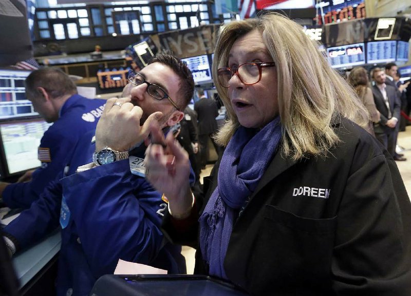 Specialist Christian Sanfilippo, left, and trader Doreen Mogavero work on the floor of the New York Stock Exchange Wednesday, Feb. 6, 2013. Strong earnings reports from media giants Disney and Time Warner aren't impressing investors in early trading, and major U.S. market indexes are opening lower. (AP Photo/Richard Drew)