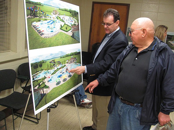 Andrew Smith (left) with Larkin Aquatics of Kansas City, Mo., describes features of the planned aquatics center at Ben Geren Park in Fort Smith to Otis Edwards of Greenwood. Edwards was one of about 50 people who attended public meetings held Monday and Tuesday in Fort Smith and Greenwood to learn about the Fort Smith/Sebastian County project. 