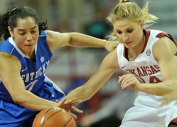 Kentucky defender Jennifer O'Neill knocks the ball away from Arkansas' Erin Gatling during the first half of Thursday night's game against the Wildcats at Bud Walton Arena in Fayetteville.