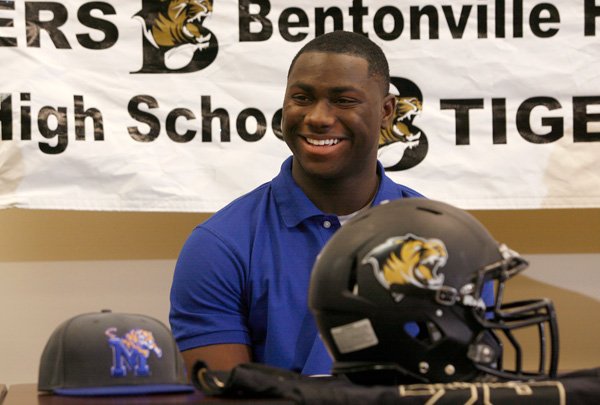 Bentonville’s Tearris Wallace laughs during a letter of intent signing ceremony inside the Tiger Athletic Complex on Wednesday at the school. Wallace signed his letter to play football at Memphis University. 