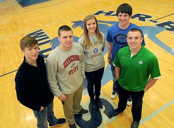 Springdale Har-Ber student athletes, from left, Jerry Wood, Peyton Squires, Sara Lachance, Winston Rasmussen and Adam Bowlin sign letters of intent to play for colleges Wednesday at Wildcat Arena in Springdale. Woods signed to play football with Ottawa University, Squires to play football for Henderson State, Lachance to play soccer for John Brown University, Rasmussen to play baseball for Crowder College and Bowlin to play football for the University of Arkansas at Monticello. 