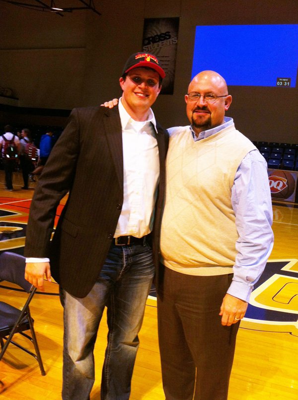 Jacob Ralph, Shiloh Christian senior, stands with Saints offensive line coach Haden Gilder after Ralph signed his National Letter of Intent with Pittsburg State on Wednesday, Feb. 6. Ralph was a two-year starter at offensive tackle for the Saints.