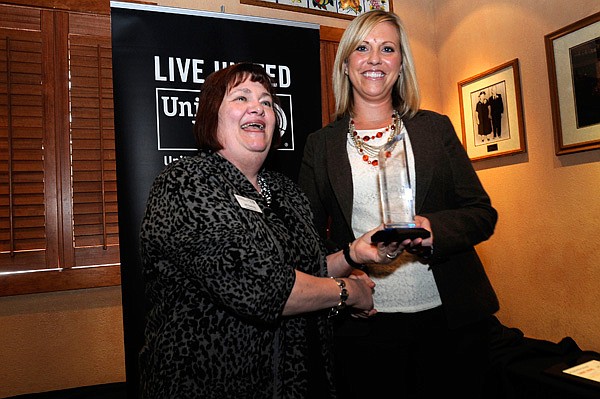 Jill Darling, left, with the Northwest Arkansas United Way, presents the Live United award Wednesday to Lauren Peterson, representing General Mills, recipient of the award. 