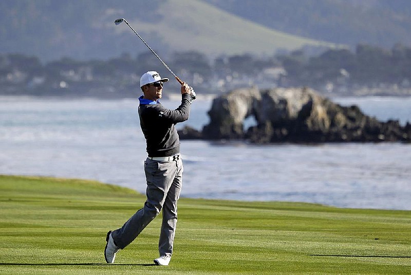 Hunter Mahan hits from the fairway on the 18th hole during the first round of the Pebble Beach Pro-Am on Thursday in Pebble Beach, Calif. Mahan birdied the hole, giving him a 66 and a share of the first-round lead. 