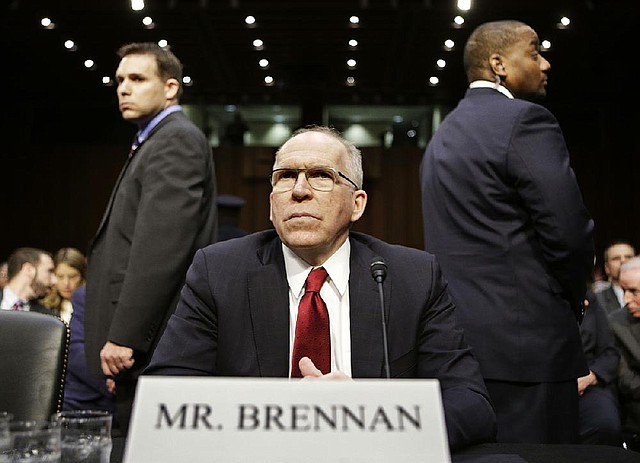 Security officers stand watch Thursday during a Senate Intelligence Committee hearing as John Brennan undergoes hours of questioning on his confirmation as CIA director. 